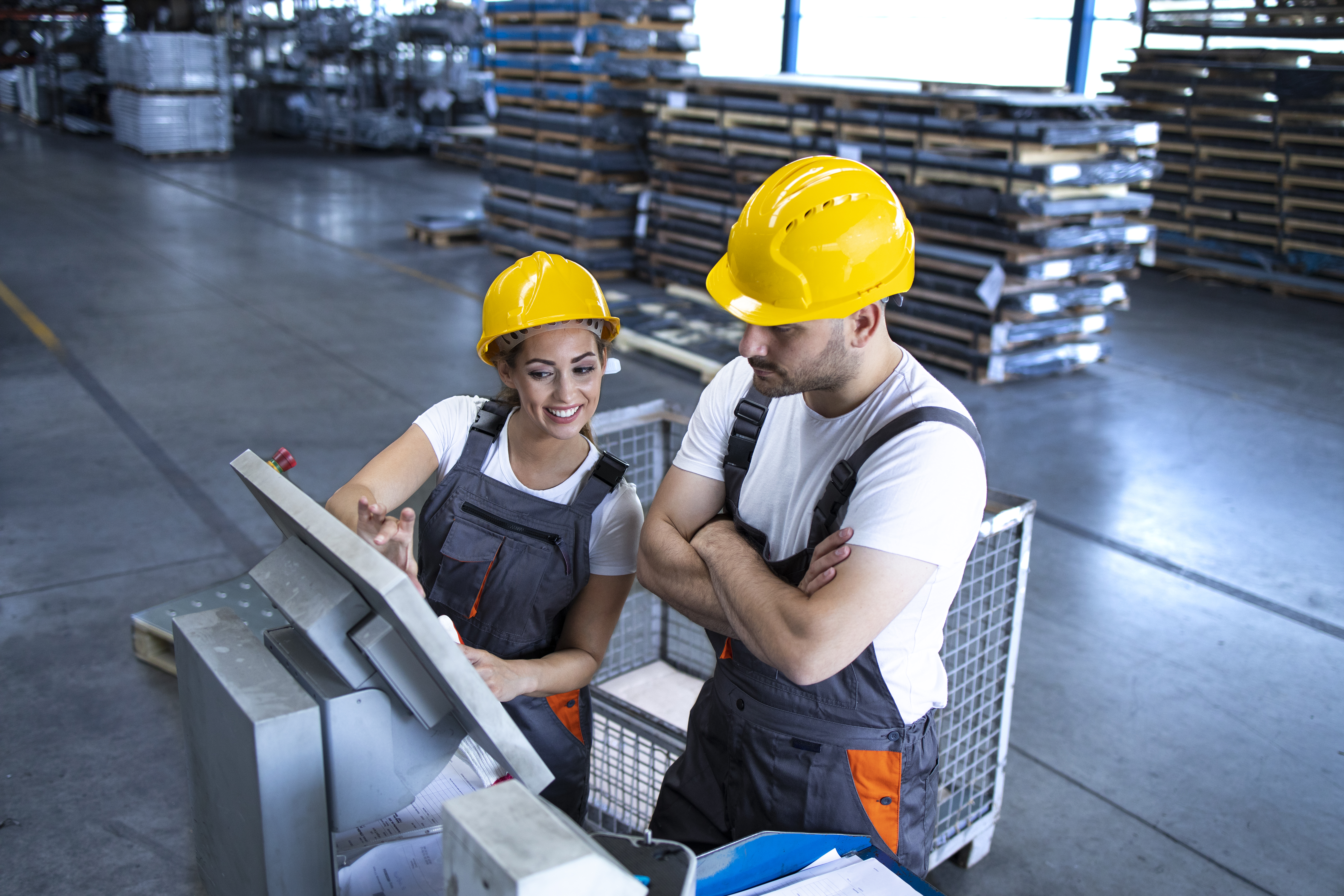 industrial-employees-with-yellow-hardhat-operating-machines-production-line-using-new-software-computer